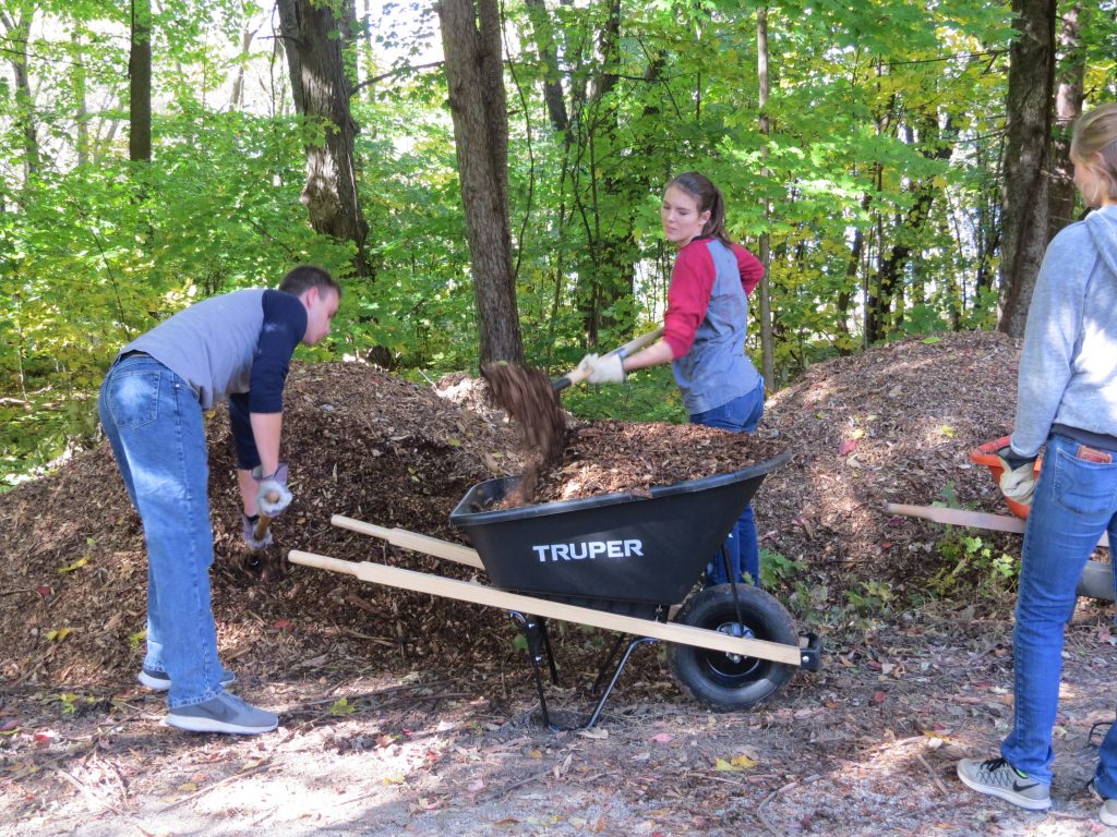 Midshipmen Nicholas Iacovo and Maren Kirkland load up mulch to repair the well-worn trails.