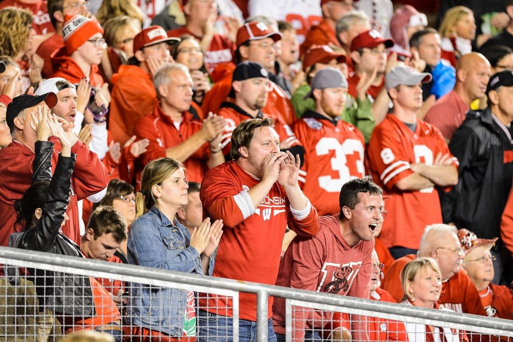 Badger fans cheer as the Wisconsin Badgers play the first half of a night football game against the Ohio State University (OSU) Buckeyes.