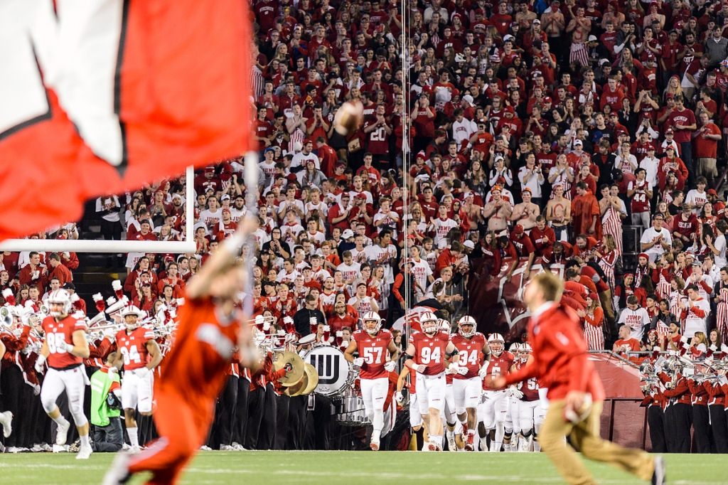 The Wisconsin Badgers come out for the second half of play in a night football game against the Ohio State University (OSU) Buckeyes.