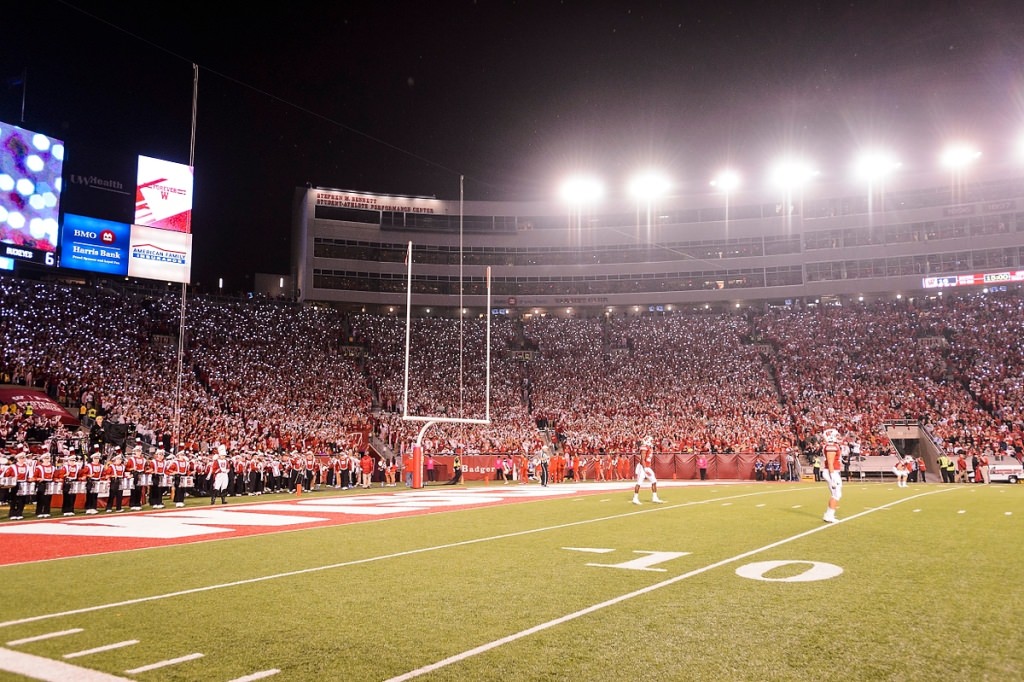 Badger fans shine their smartphone lights as the Wisconsin Badgers come out for the second half of play in a night football game against the Ohio State University (OSU) Buckeyes at Camp Randall Stadium.