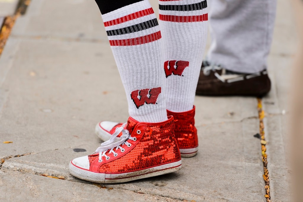 Sporting Wisconsin-themed socks and bedazzled red shoes, a Badger fan walks to Camp Randall Stadium.