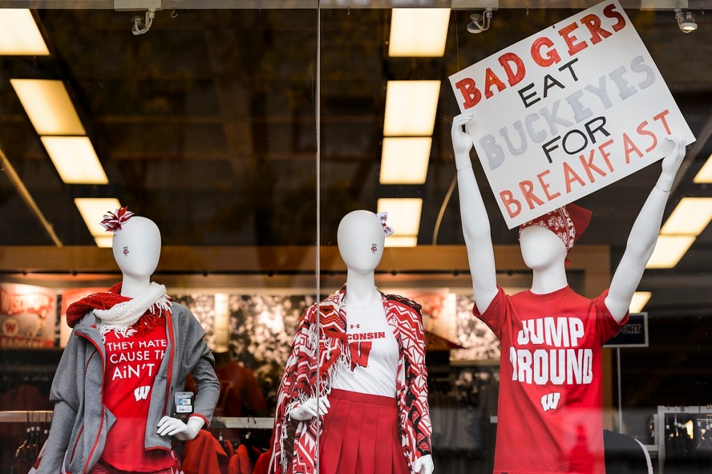 Wisconsin-themed attire and signs are displayed in a University Book Store window before the start of the Badgers' game against Ohio State University.