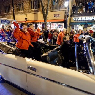 Chancellor Rebecca Blank and her husband, Hanns Kuttner, wave to the crowd.