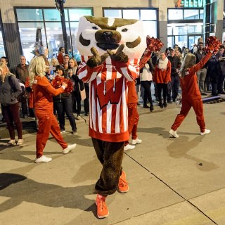 Bucky Badger waves to the thousands of spectators lining State Street.