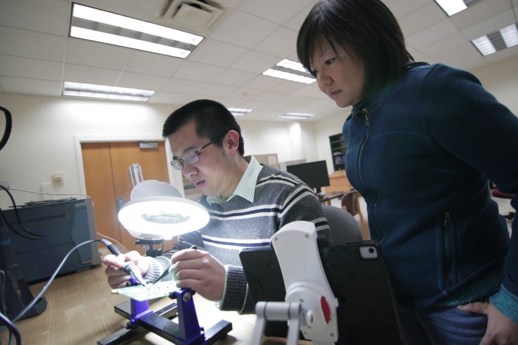 The automated testing platform built by Jing Li and her students allows them to evaluate the performance of the new liquid silicon chips. 