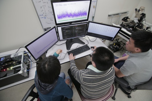 Software written by Jing Li, right, and her students allows programmers to directly use existing coding languages with the new Liquid Silicon chips