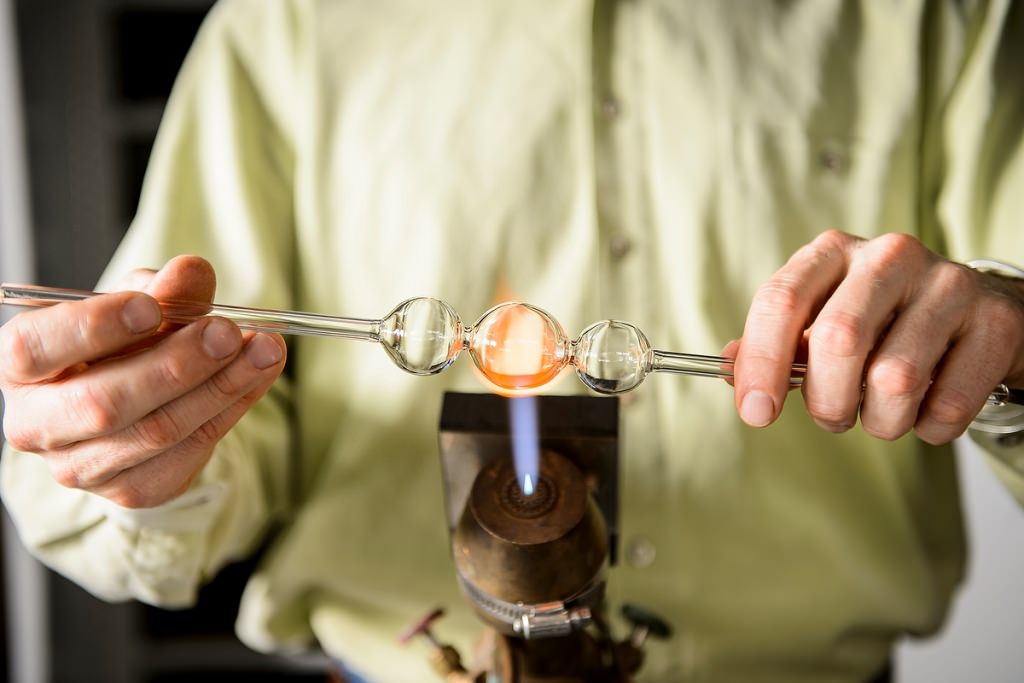 Fired up: The chemistry department's master glassblower, Tracy Drier, employs a blowtorch to create a highly specialized lab instrument. Drier was one of nine 2016 Academic Staff Excellence Award recipients.