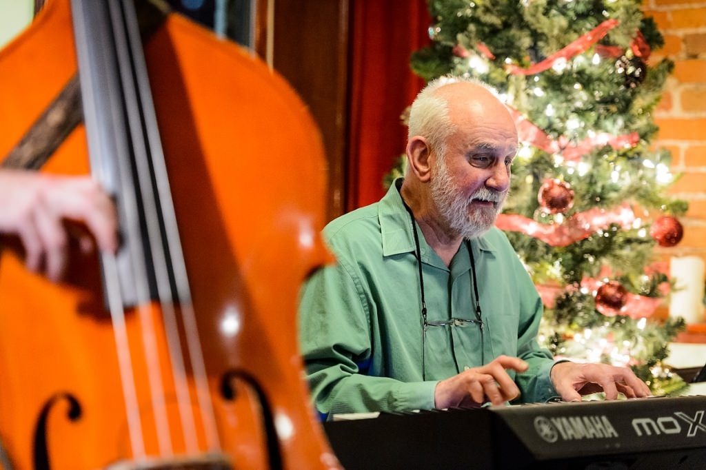 Fred Blattner, an emeritus professor of genetics and an entrepreneur, plays electric piano during the Sunday Jazz Jam at The Rigby Bar and Grill in downtown Madison on Dec. 4.