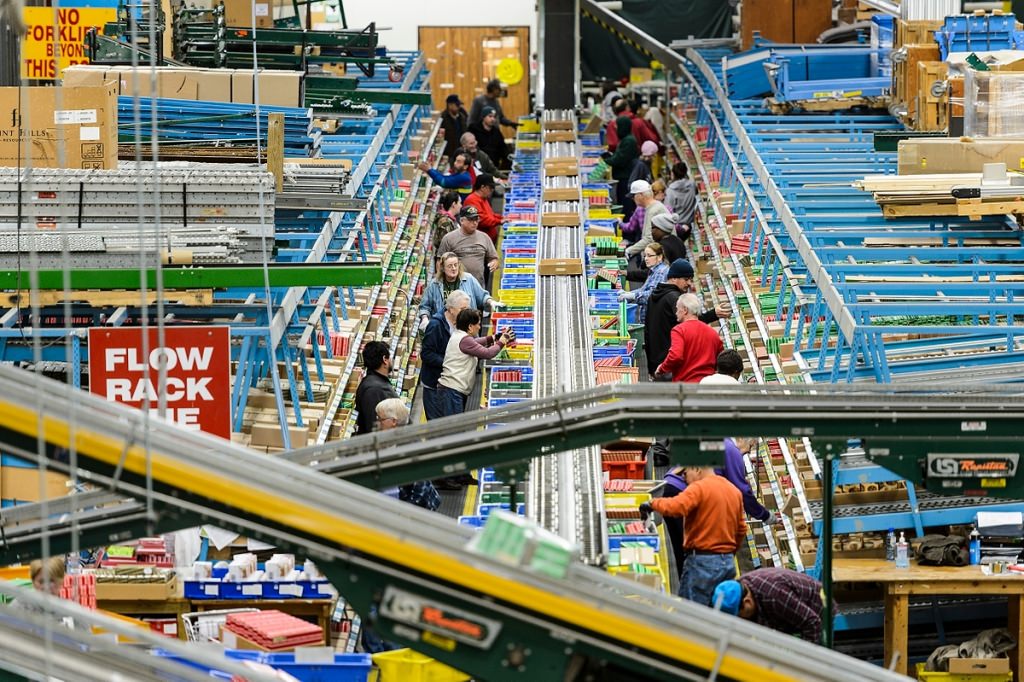 Staff sort and prepare merchandise moving along a series of warehouse conveyor belts at a food packaging and shipping facility at Colony Brands in Monroe, Wis. Colony Brands began as The Swiss Colony -- a mail-order cheese business model launched in 1926 by Ray Kubly, Sr., who graduated that same year from the University of Wisconsin -- and has evolved into a thriving billion-dollar-a-year, multi-catalog industry in Southwest Wisconsin. 