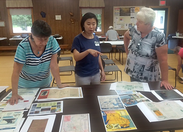 At the Barnes Town Hall. UW–Madison graduate student Catherine Hannula, center, speaks with Tam Larson, of the Barnes Area Historical Association, and a local attendee.