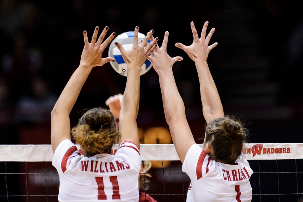 Photo: Wisconsin middle blocker Tionna Williams (11) and setter Lauren Carlini (1) block a shot at the net.