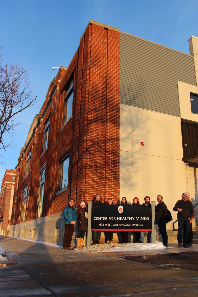 Staff members of the Center for Healthy Minds outside their new office at the renovated Kennedy Dairy Building, 625 W. Washington Ave. 