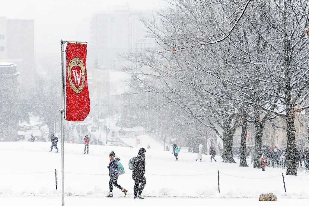 As a fresh coat of snow falls, students make their way to class.