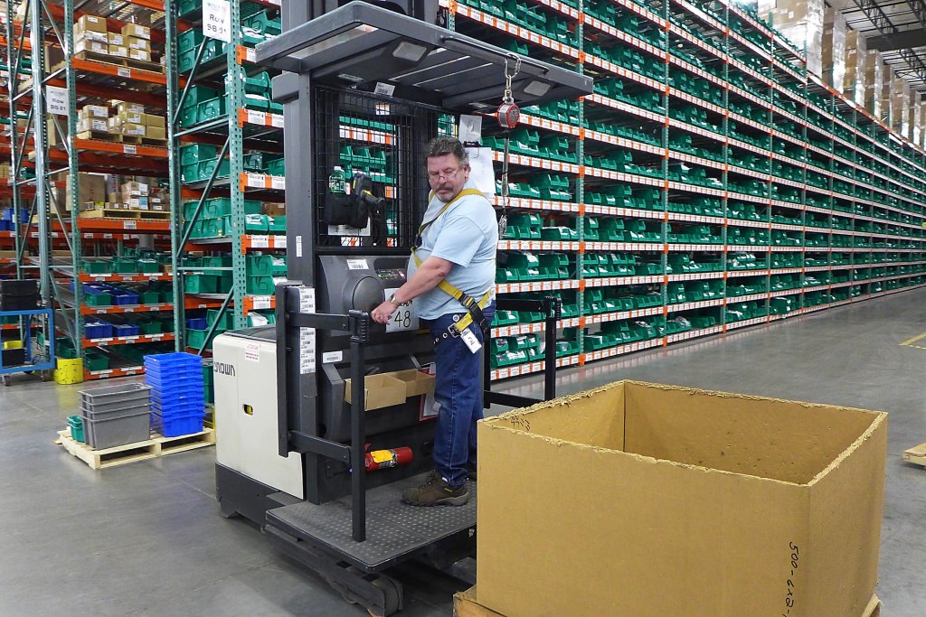 Workers on lift trucks pick parts from more than one-half million stocked items at the Endries warehouse in Brillion, Wisconsin. Endries International, of Brillion, Wisconsin, has announced an electronic system to ensure that the parts bins it maintains at customer’s factories hold optimal inventory to meet customer's changing needs. The system was developed in conjunction with the University of Wisconsin Electronic Business Consortium. Photo by David Tenenbaum/University Communications