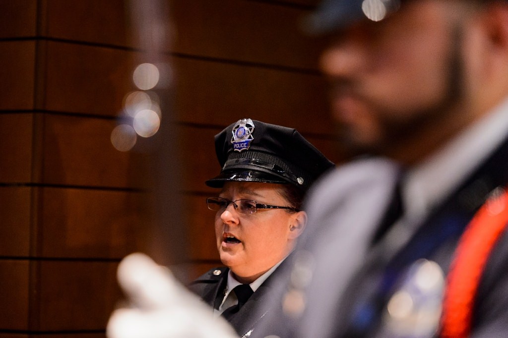 Kim Brunner, a UW Police dispatch officer, sings the national anthem as part of a formal swearing-in ceremony for UW Police Department Chief Kristen Roman at Union South's Marquee Cinema at the University of Wisconsin-Madison on Feb. 1, 2017. (Photo by Jeff Miller/UW-Madison)