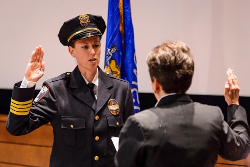 At left, UW Police Department Chief Kristen Roman pledges the Oath of Office to retired Police Chief Susan Riseling, right, during Roman's formal swearing-in ceremony at Union South's Marquee Cinema at the University of Wisconsin–Madison on Feb. 1, 2017. (Photo by Jeff Miller/UW-Madison)