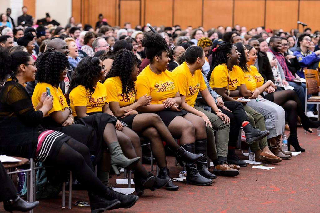 Members of the Black History Month Planning Committee react with laughter to Giovanni's quick wit.