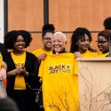 Members of the Black History Month Planning Committee present Giovanni with a commemorative t-shirt following Giovanni's talk.