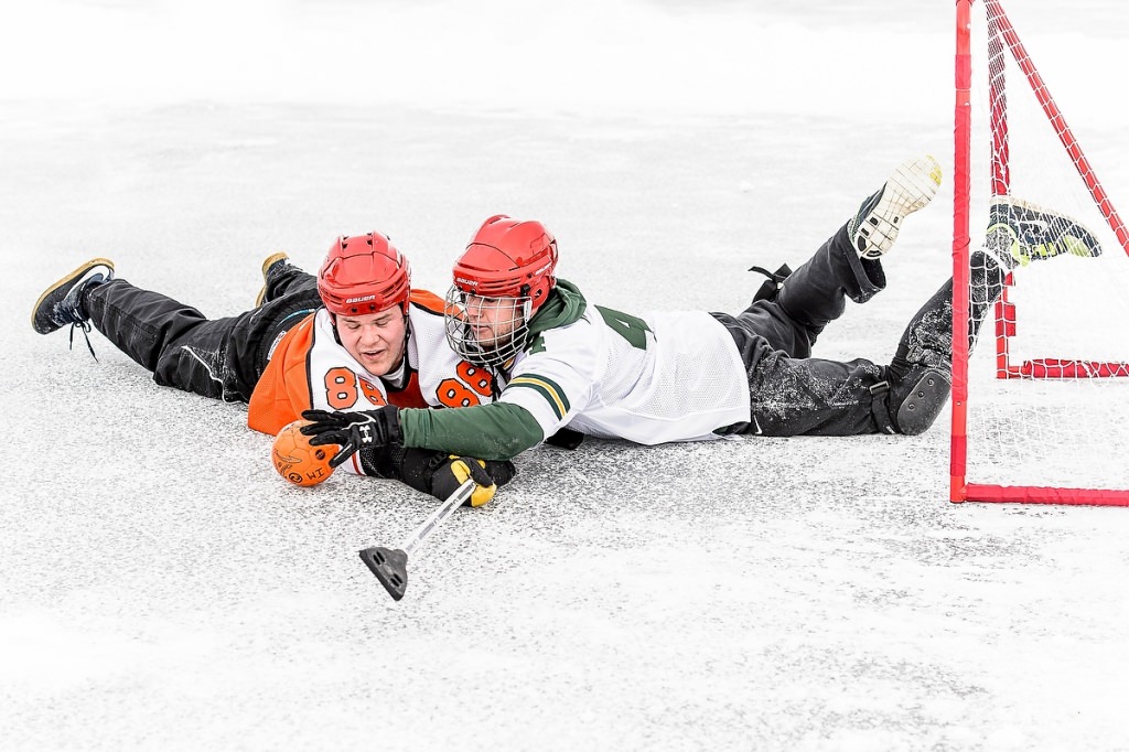 Joey Horan, left, and James Oelke, right, fight for possession during the broomball tournament.