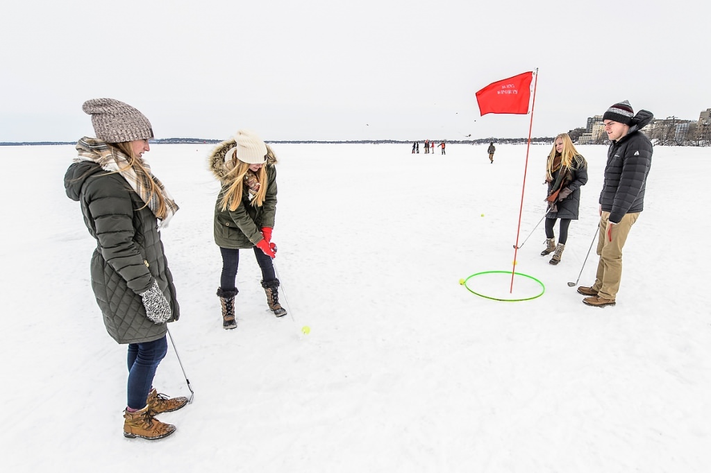 Montana Hodur lines up her putt as Ashley Squiares (left), Courtney Klatt and Dan Klundt look on.