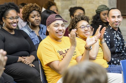 Audience members applaud during a dedication and libation ceremony for the new Black Cultural Center.