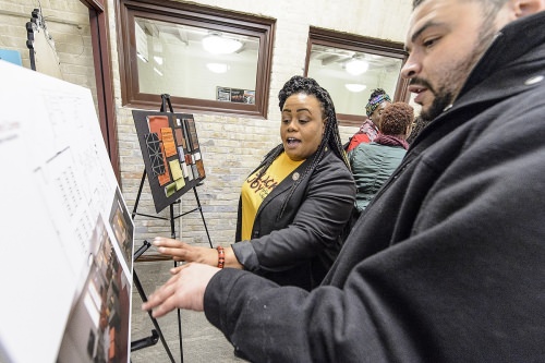 Karla Foster, campus and community liaison for the Pathways to Educational Achievement and interim program coordinator for the Multicultural Student Center, discusses design plans during the dedication.