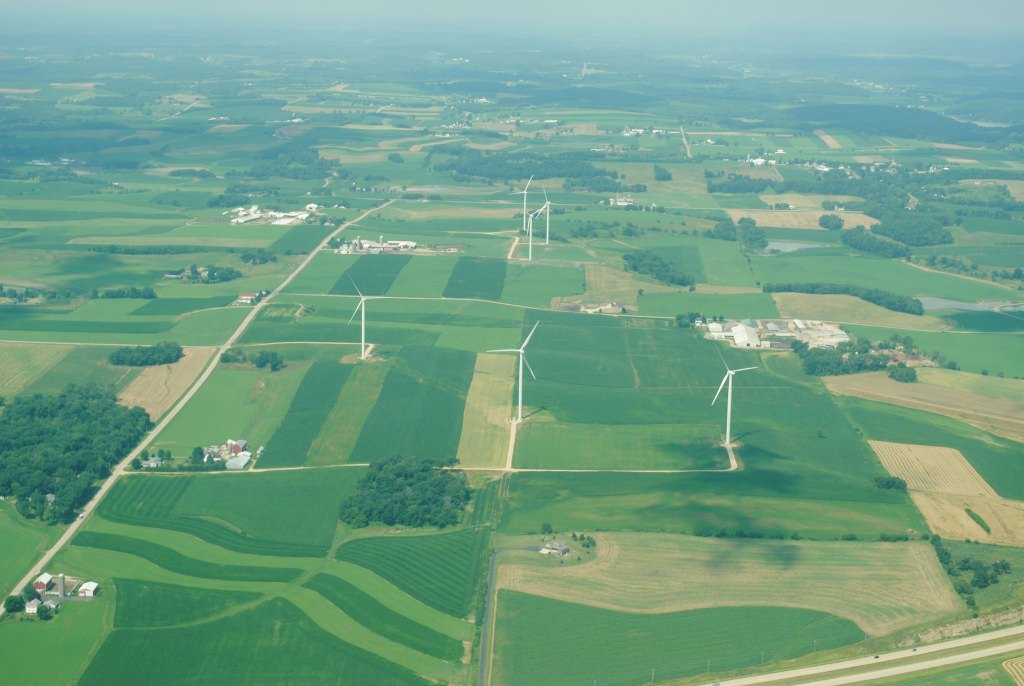 Photo: Aerial view of farm fields and wind turbines