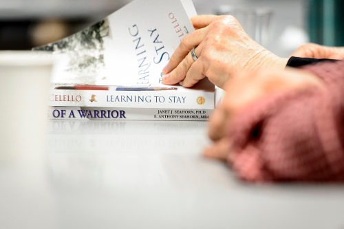 A participant searches for a passage of text during a discussion session held by the Warrior Book Club.