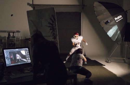 A stobe captures the action in Foot Lockers photo studio at its Wausau offices. 