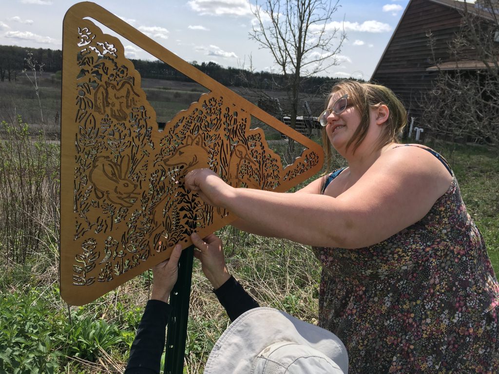 Photo: Liz Kozik installing sign