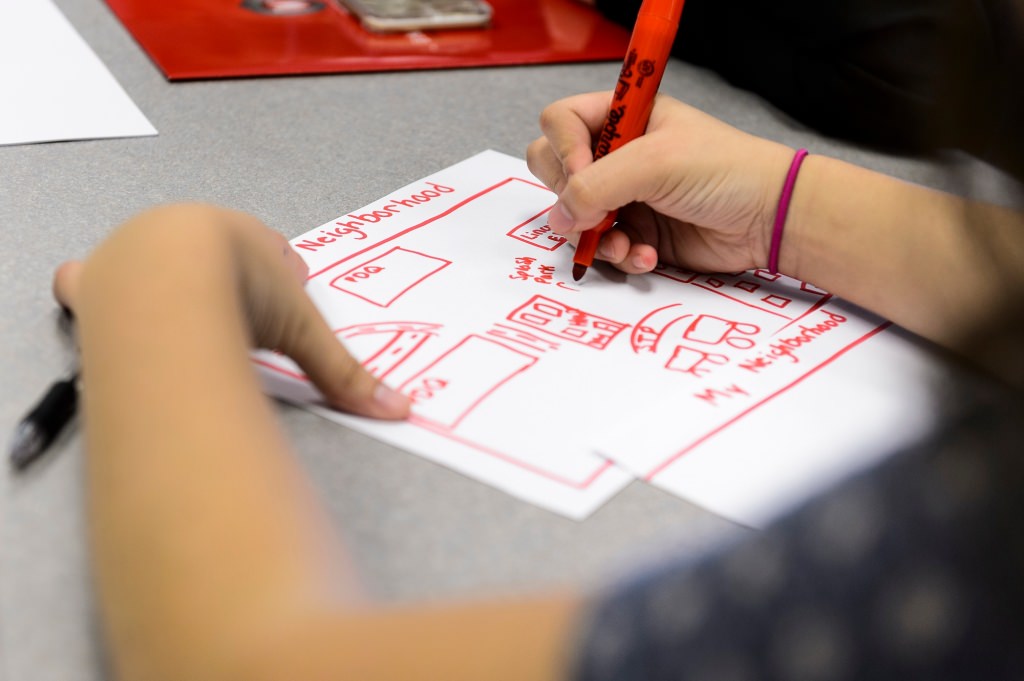 Photo: Closeup of neighborhood picture being drawn by a student