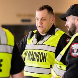 University Police Lieutenant Mark Silbernagel, center, coordinates with other UWPD officers staged inside the Kohl Center at the University of Wisconsin-Madison as they monitor a community protest -- directed at the nearby Madison Metropolitan School District offices -- occurring outside building on April 4, 2017. Silbernagel is one of eight recipients of a 2017 University Staff Recognition Award (USRA). (Photo by Jeff Miller/UW-Madison)