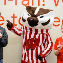 Undergraduate Jacob Lindemann and his brother Adam, 13, of Manitowoc, pose for a photo with mascot Bucky Badger at Union South during Sibs Day activities.