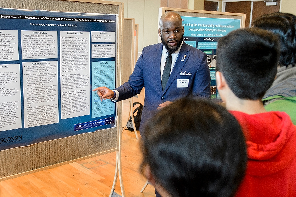 Chetachukwu Agwoeme discusses his research at the Undergraduate Symposium on April 13. A record 683 students took part.