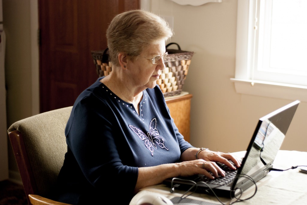 Photo: Elderly woman at laptop computer