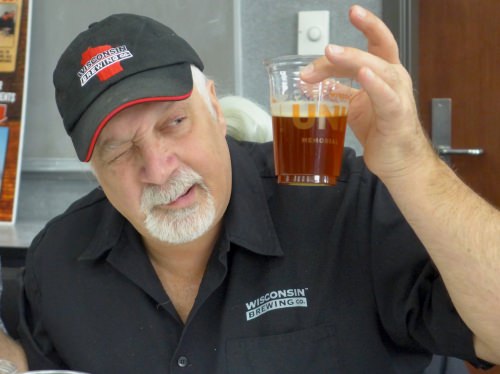 Kirby Nelson, brewmaster at Wisconsin Brewing, Verona Wisconsin, sizes up one of the six beers being judged at Babcock Hall.  