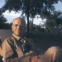 Photo: Aldo Leopold sitting outdoors with binoculars