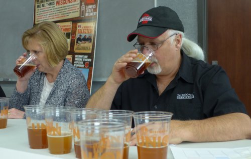 Kirby Nelson and Suzanne Thompson at work judging beers during the Campus Craft Brewery competition. Thompson, a Food Science graduate, manages quality systems and regulatory compliance at MillerCoors in Milwaukee, and oversees the corporate analytical and sensory labs.   