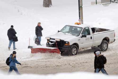 A Physical Plant truck plows snow and salts a slippery pedestrian walkway along Linden Drive in 2007. Such salt is raising the salt levels of freshwater lakes.