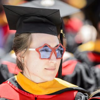 A graduate sports a pair of festive sunglasses.