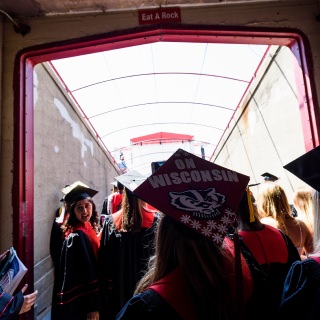 Thousands of family and friends await the graduates' entrance.