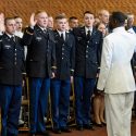 Led by Rear Adm. Stephen C. Evans, commander of the U.S. Naval Service Training Command, right, members of UW-Madison's Army, Navy and Air Force Reserve Officer Training Corps take the oath of office during a ceremony Saturday. The event formally recognized 32 graduates from UW-Madison as officers in the military.