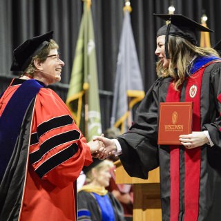 Chancellor Blank congratulates a graduate.