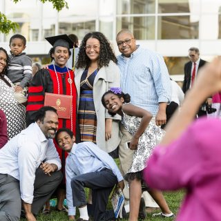 Communication Arts doctoral graduate Laura Stephenson takes a photo with her family.