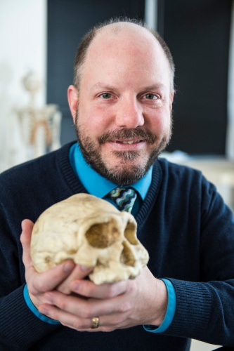 Photo: John Hawks holding skull