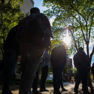 UW-Madison faculty and staff have been connecting with people through the Wisconsin Idea Seminar since 1985. Here, driver Stuart Helke, welcomes the latest participants onto the first leg of their journey. Helke has been driving for the seminar since the 1990s.