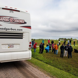 Participants examine beds of cranberries at the Gottschalk marshes. The Gottschalk family discussed their multi-generational farm and the importance of combining traditional and modern farming techniques.