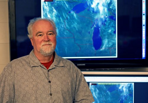 Photo: Brad Pierce in front of projected map of Lake Michigan