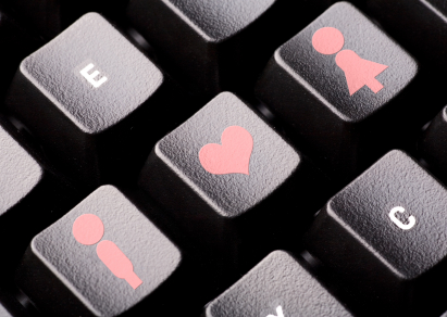 Man, woman, and heart icons on a computer keyboard