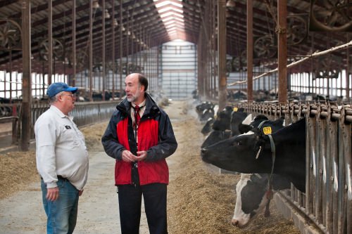 Photo: Byron Crouse talking to a dairy farmer